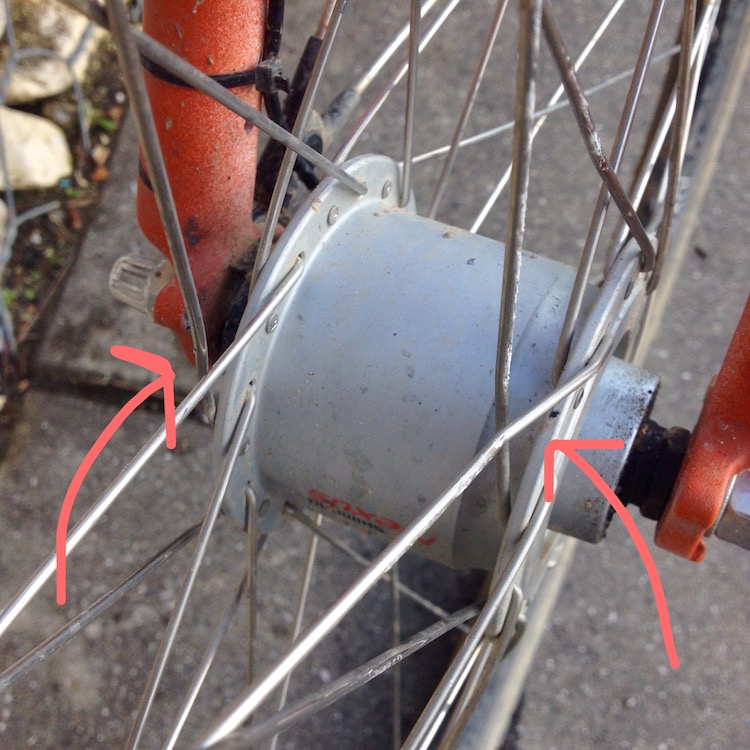 Close-up of the front wheel spokes, showing the bends where they were pressed against the drainage slot