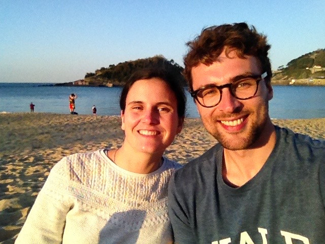 Joana and Dan on the beach in San Sebastián, sun shining on their faces