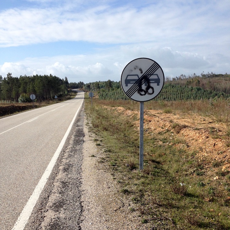 A small road sign, with a crude penis graffiti'd on it